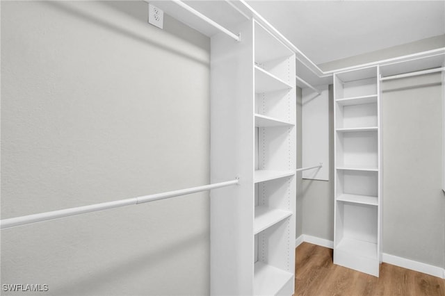 spacious closet with wood finished floors