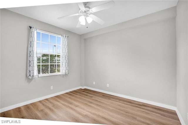 unfurnished room featuring a ceiling fan, light wood-style flooring, and baseboards