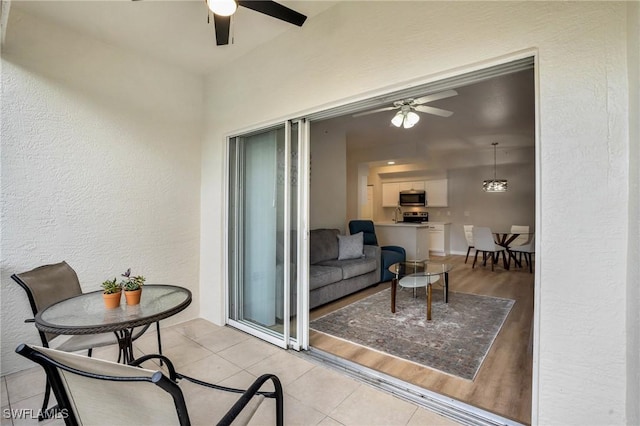 balcony featuring a patio area and ceiling fan