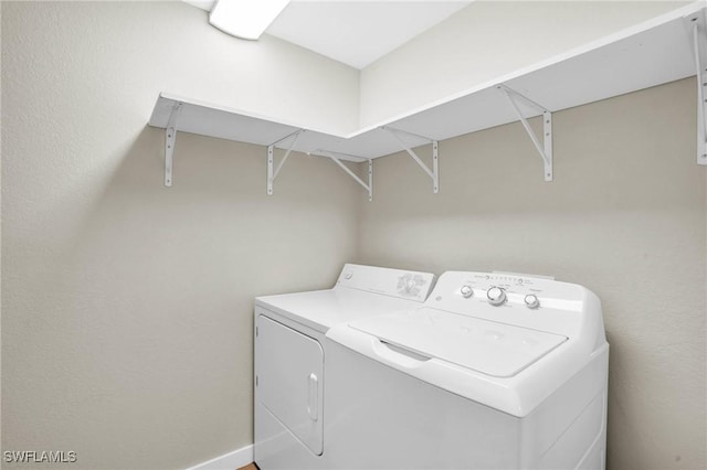 clothes washing area featuring washing machine and dryer and laundry area