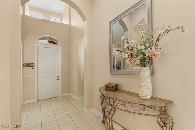 entryway with light tile patterned flooring