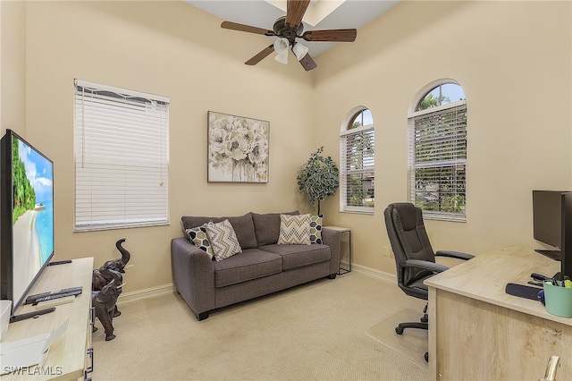 carpeted office with ceiling fan and a healthy amount of sunlight