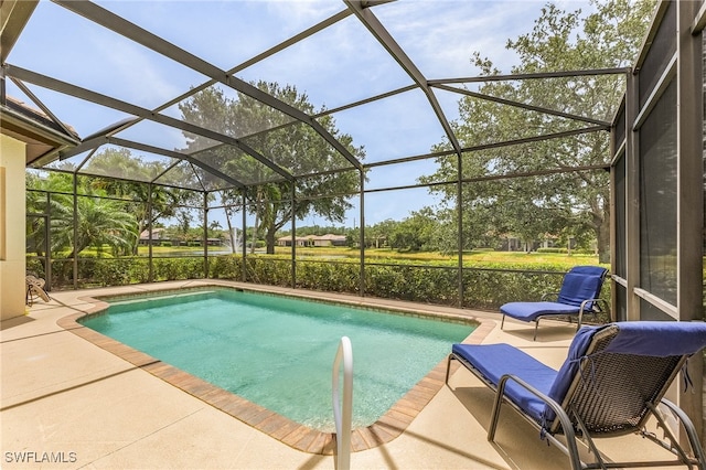 view of swimming pool with glass enclosure and a patio