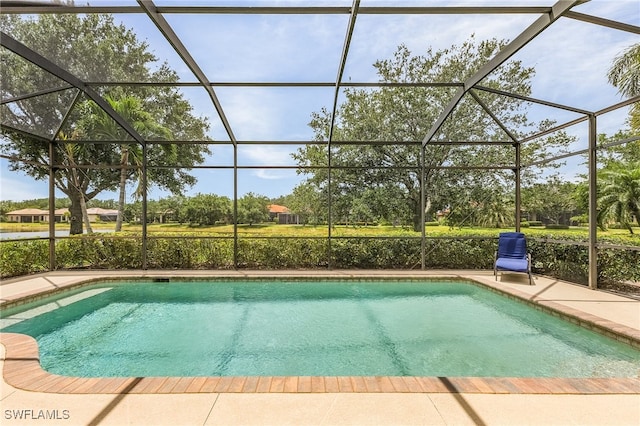 view of pool with glass enclosure