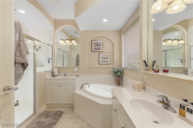 bathroom with independent shower and bath, vanity, and tile patterned flooring