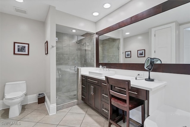 bathroom with tile patterned floors, toilet, vanity, and a shower with shower door