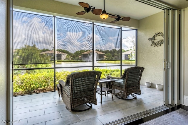 sunroom / solarium featuring ceiling fan