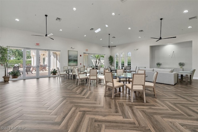 dining area with ceiling fan, parquet flooring, plenty of natural light, and french doors