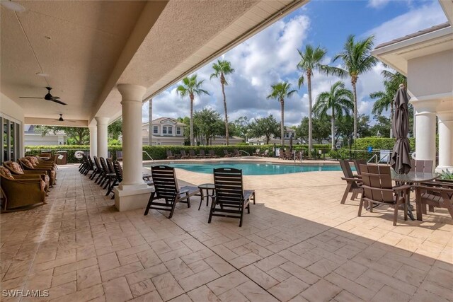 view of swimming pool with ceiling fan and a patio area