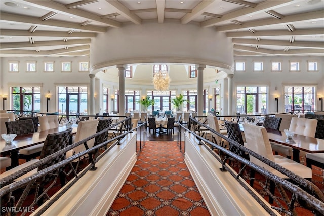 gym with decorative columns and a high ceiling