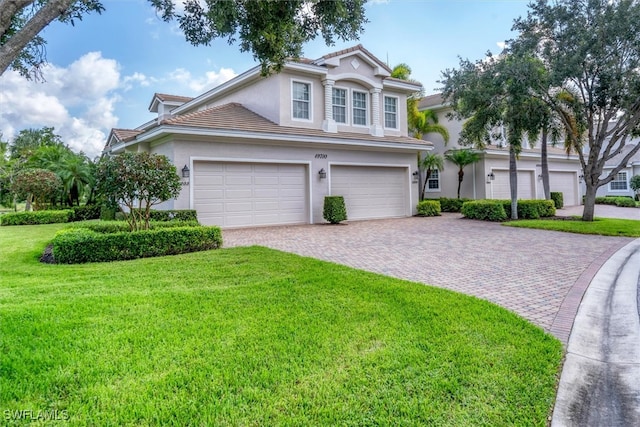 view of front facade with a garage and a front lawn