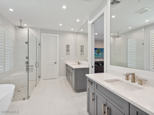 bathroom featuring tile patterned floors, plus walk in shower, and dual bowl vanity