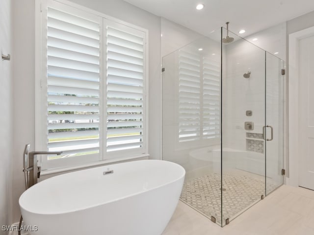 bathroom with independent shower and bath and tile patterned floors