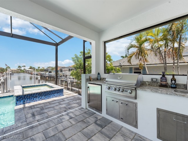 view of patio with glass enclosure, a pool with hot tub, a water view, a grill, and an outdoor kitchen