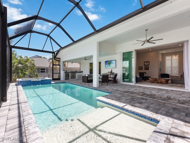 view of pool featuring ceiling fan, outdoor lounge area, glass enclosure, an in ground hot tub, and a patio area