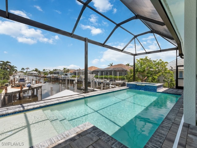 view of swimming pool featuring an in ground hot tub, a boat dock, a water view, and a lanai