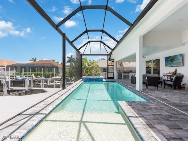 view of pool with a lanai, outdoor lounge area, and a patio