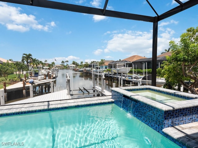 view of pool featuring pool water feature, glass enclosure, a water view, and a dock