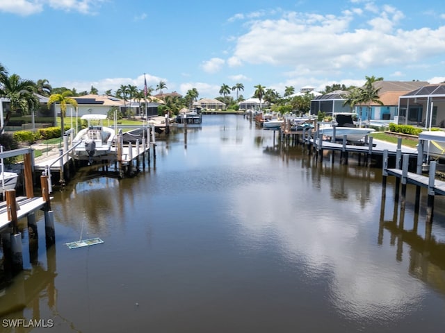 dock area featuring glass enclosure and a water view