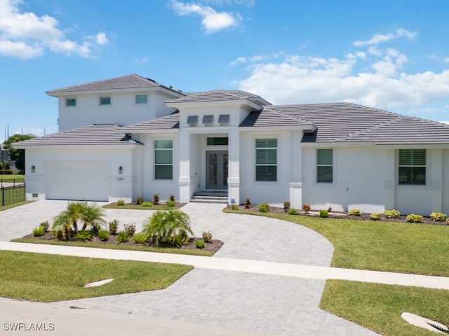 view of front of home with a garage and a front yard