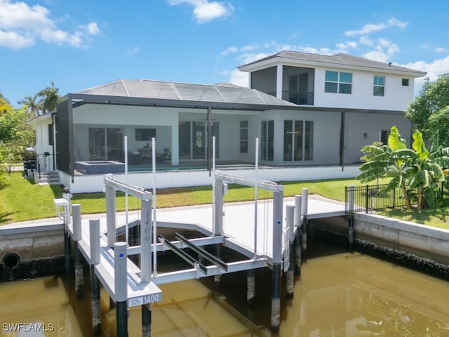 view of dock featuring glass enclosure and a yard