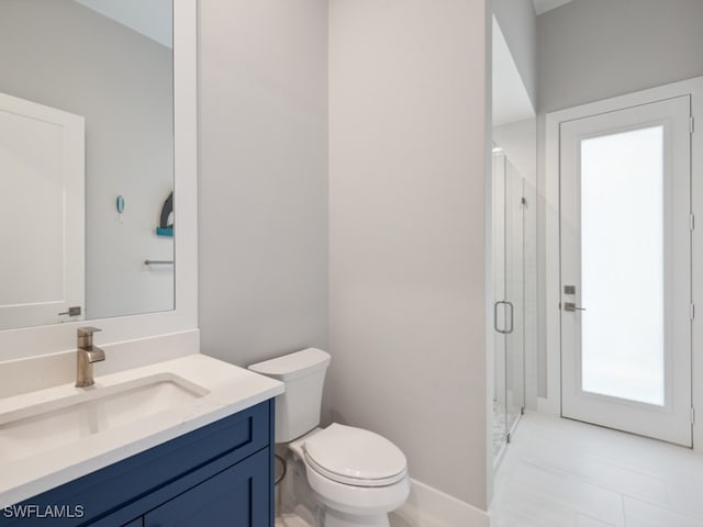 bathroom with tile patterned flooring, a shower with door, vanity, and toilet