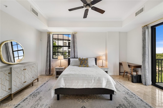 tiled bedroom with multiple windows, ornamental molding, a tray ceiling, and ceiling fan