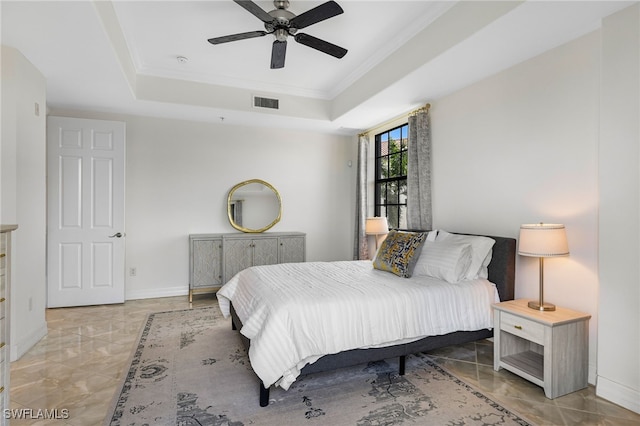 bedroom featuring ceiling fan, light tile patterned floors, and a tray ceiling