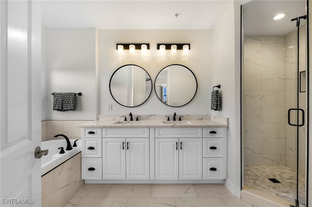 bathroom with tile patterned floors, shower with separate bathtub, and vanity