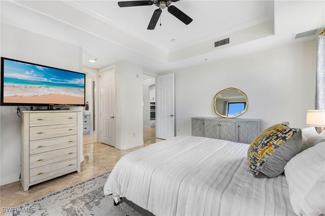 bedroom with ceiling fan, a raised ceiling, and light tile patterned floors