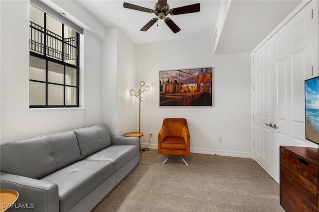 living room featuring ceiling fan and light colored carpet