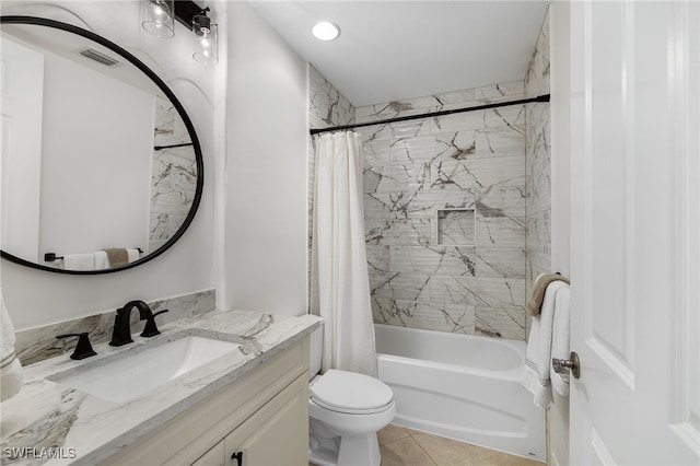 full bathroom featuring tile patterned floors, shower / bath combo with shower curtain, vanity, and toilet