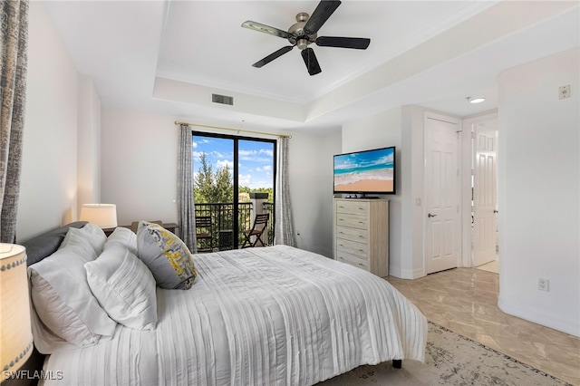 bedroom with ceiling fan, a raised ceiling, light tile patterned floors, and access to outside