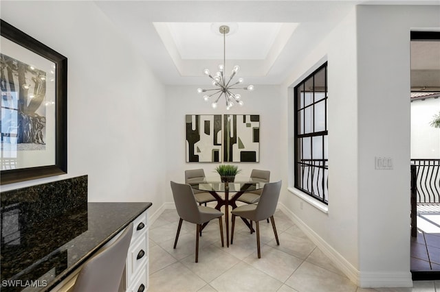 dining room with a wealth of natural light, a raised ceiling, a chandelier, and light tile patterned floors