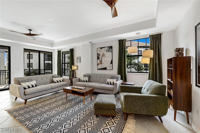 tiled living room featuring a tray ceiling and ceiling fan