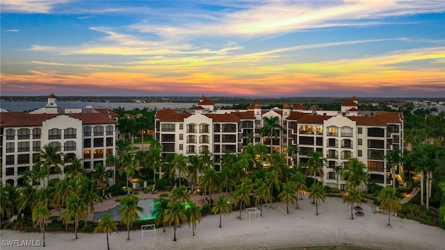 outdoor building at dusk with a beach view and a water view