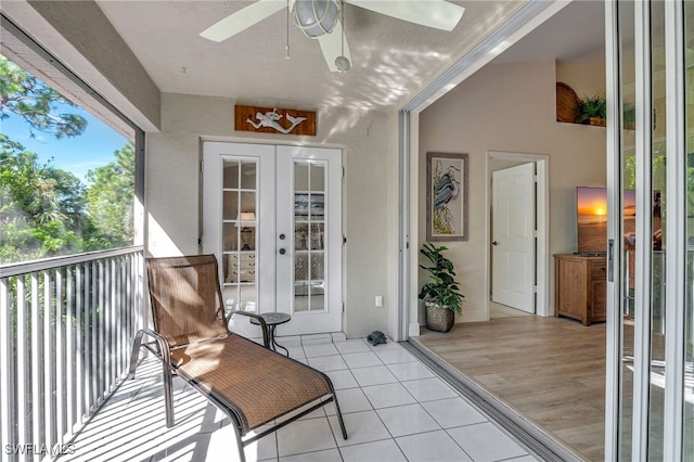 balcony with ceiling fan and french doors