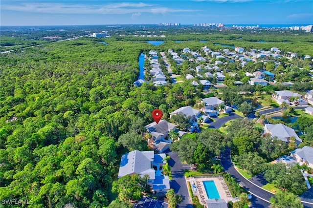 737 Wiggins Lake Dr Unit 201, Naples, FL 34110 - aerial view of property's location with a heavily wooded area and a pool
