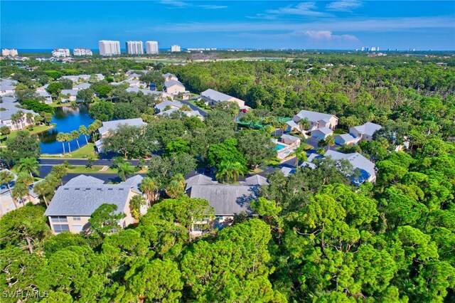 737 Wiggins Lake Dr Unit 201, Naples, FL 34110 - aerial view of property and surrounding area featuring nearby suburban area and a forest