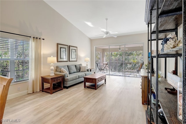 living room featuring ceiling fan, high vaulted ceiling, a healthy amount of sunlight, and light hardwood / wood-style floors