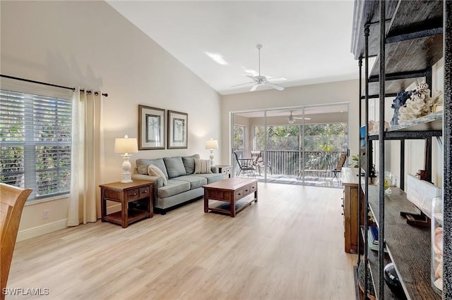 737 Wiggins Lake Dr Unit 201, Naples, FL 34110 - living area featuring ceiling fan, light wood-type flooring, baseboards, and high vaulted ceiling