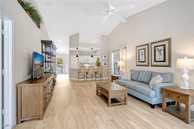 living room featuring ceiling fan, high vaulted ceiling, and light hardwood / wood-style floors