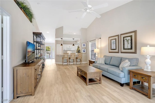 737 Wiggins Lake Dr Unit 201, Naples, FL 34110 - living room with ceiling fan, light wood-style flooring, high vaulted ceiling, and baseboards