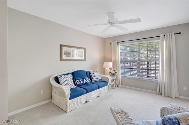 living area featuring carpet and ceiling fan