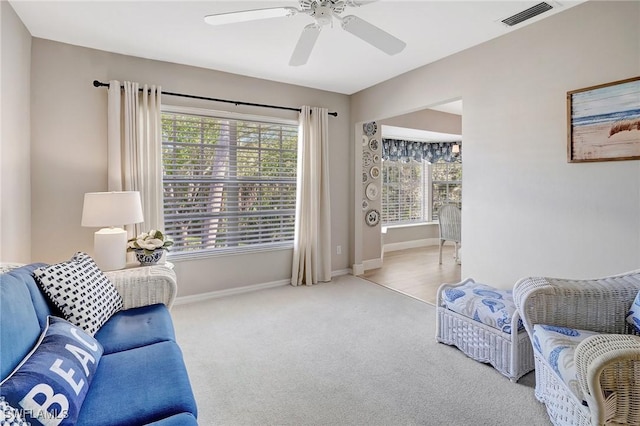 737 Wiggins Lake Dr Unit 201, Naples, FL 34110 - living room featuring carpet, a ceiling fan, and baseboards