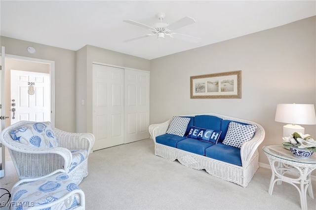 carpeted living room with ceiling fan