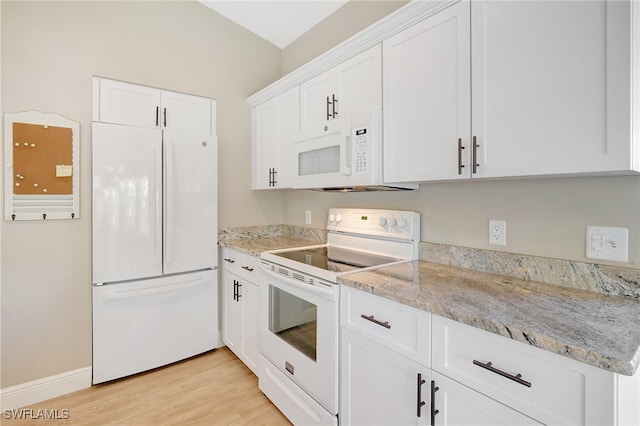 kitchen featuring white appliances, light hardwood / wood-style flooring, white cabinetry, and light stone counters