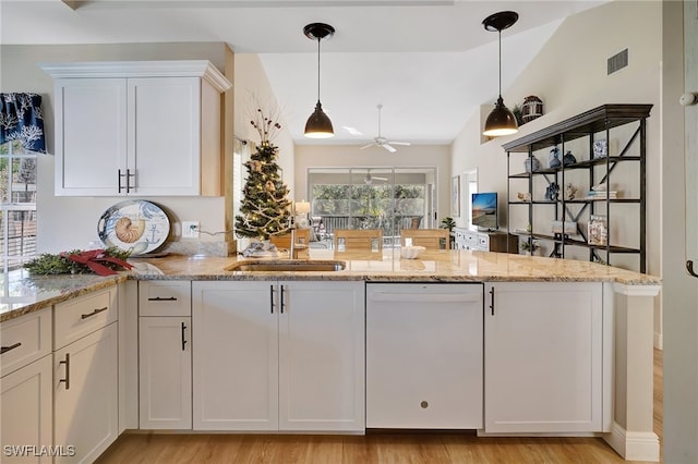 kitchen with dishwasher, white cabinetry, vaulted ceiling, and light hardwood / wood-style floors