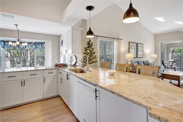 kitchen featuring dishwasher, sink, light hardwood / wood-style flooring, light stone countertops, and white cabinetry