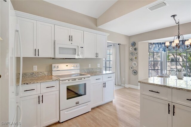 kitchen with white cabinets, white appliances, and a notable chandelier